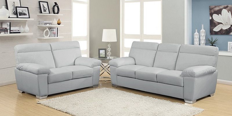 luxury living room in Dubai with light grey velvet sofa and heavy charcoal grey curtains
