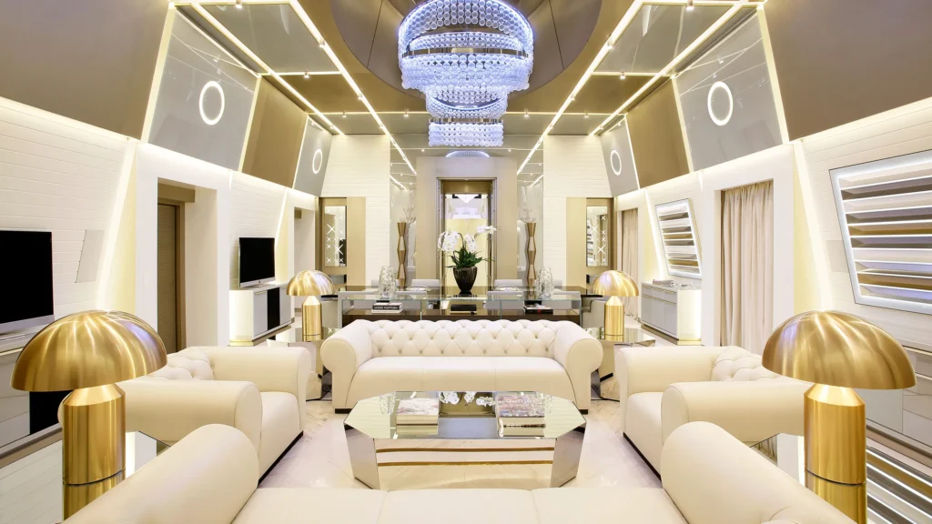 A luxurious modern Dubai living room showcasing elegant custom-upholstered furniture — velvet sofas, designer chairs, and rich textures. Warm natural lighting, gold accents, and soft neutral tones. The atmosphere exudes comfort, craftsmanship, and class — representing luxury upholstery services Dubai by Curtains Dubai Supplier.