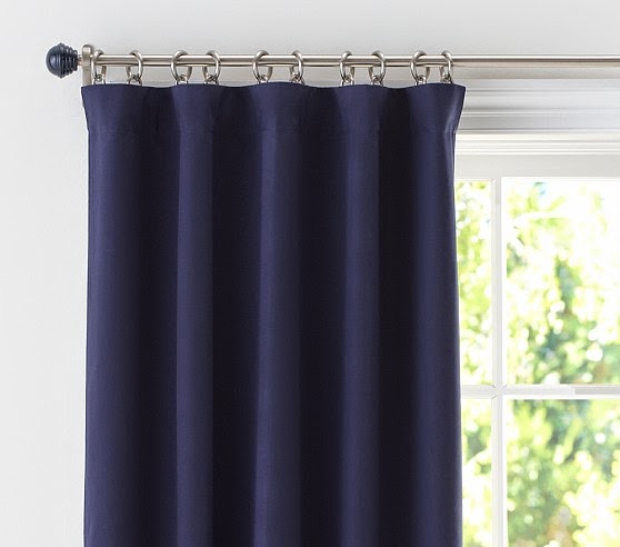 Blackout curtains in Dubai bedroom blocking sunlight completely